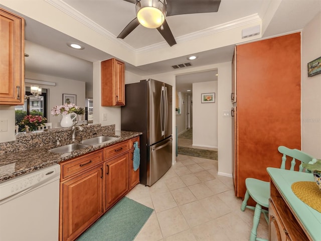 kitchen featuring stainless steel refrigerator, sink, dark stone countertops, white dishwasher, and crown molding