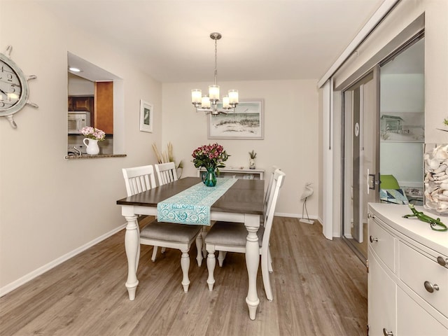 dining area featuring a chandelier and light hardwood / wood-style floors