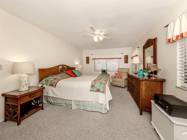 bedroom with ceiling fan and light colored carpet