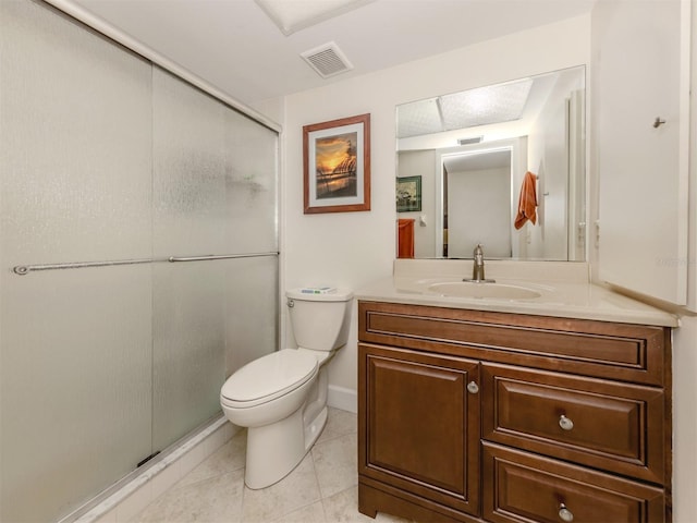 bathroom featuring vanity, toilet, an enclosed shower, and tile patterned flooring