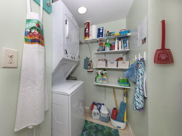 laundry area featuring stacked washer and dryer and light tile patterned floors