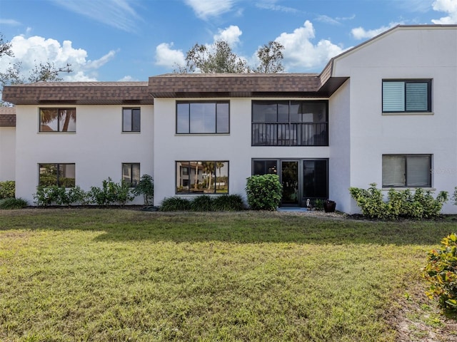 rear view of property with a yard