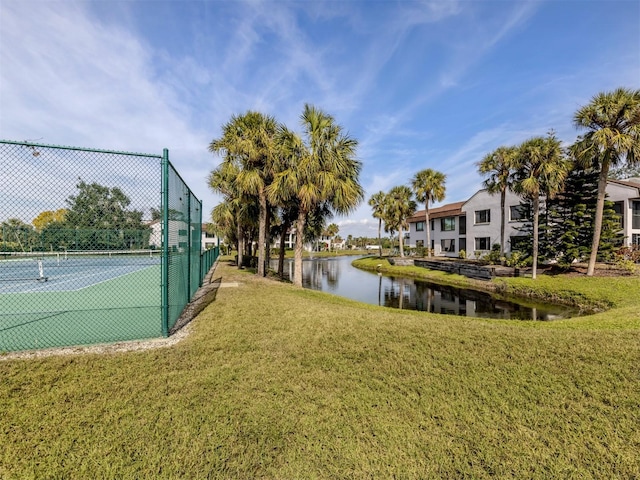 exterior space featuring a water view and a lawn