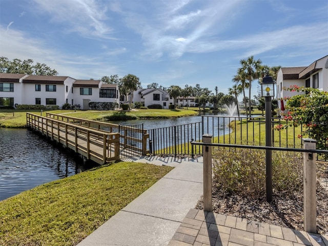 dock area featuring a water view and a yard