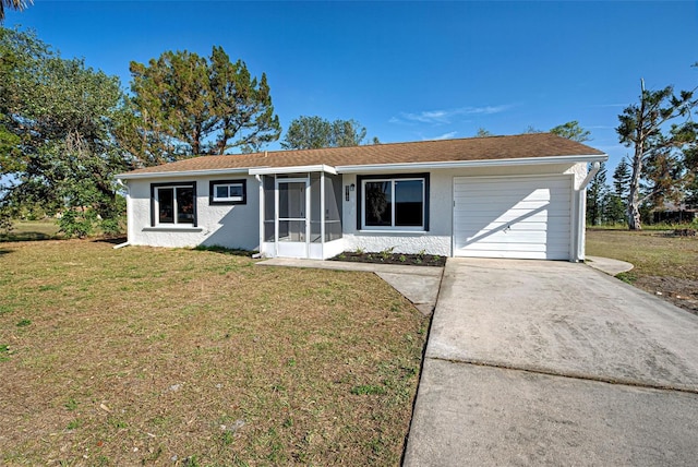 single story home with a garage, a sunroom, and a front yard