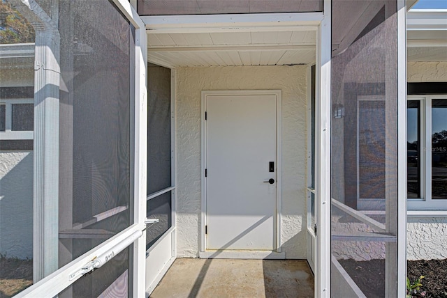 view of exterior entry with stucco siding