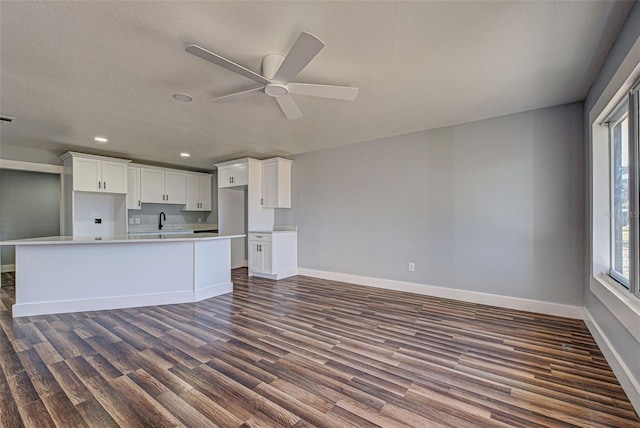 kitchen featuring sink, ceiling fan, a kitchen island with sink, white cabinets, and dark hardwood / wood-style flooring