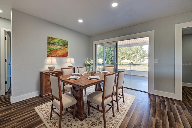 dining room featuring dark wood-type flooring and vaulted ceiling