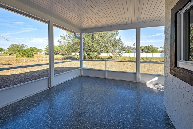 unfurnished sunroom with wood ceiling