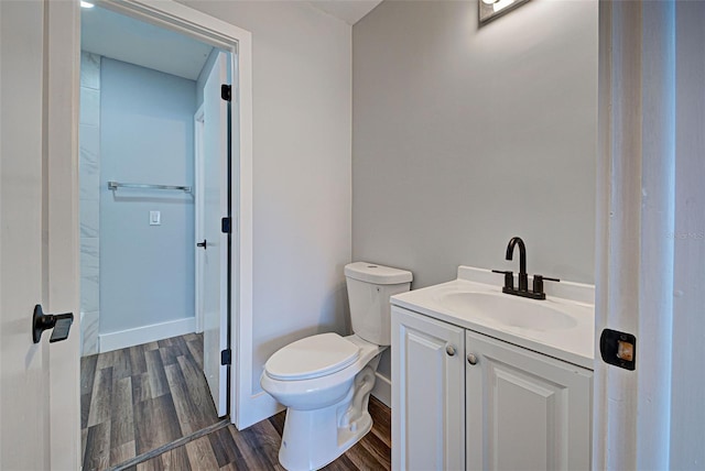 bathroom with vanity, hardwood / wood-style flooring, and toilet