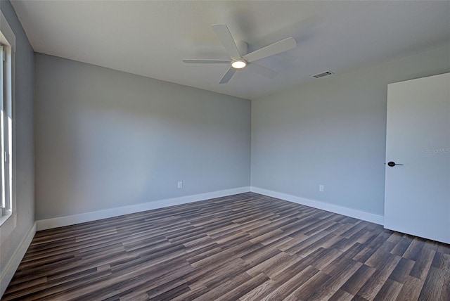 spare room featuring dark wood-type flooring and ceiling fan