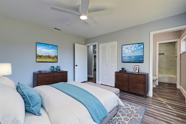 bedroom featuring ensuite bath, dark wood-type flooring, a closet, and ceiling fan