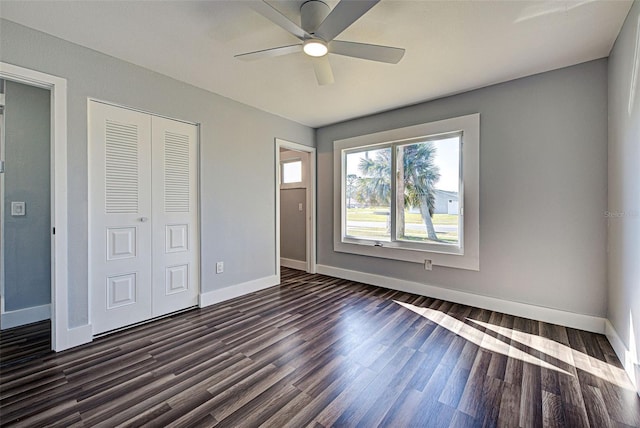 unfurnished bedroom featuring dark hardwood / wood-style flooring, a closet, and ceiling fan