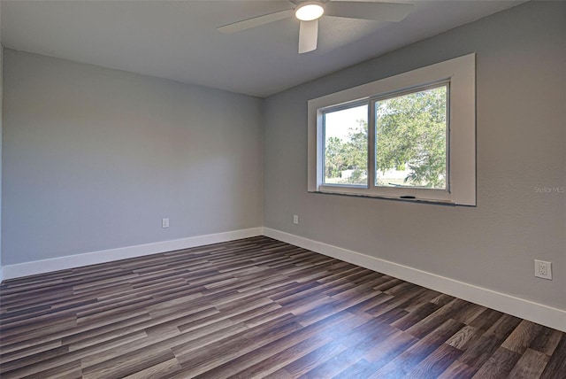 empty room with dark wood-type flooring and ceiling fan