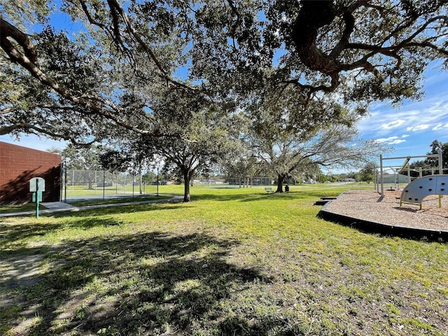 view of yard with fence and playground community