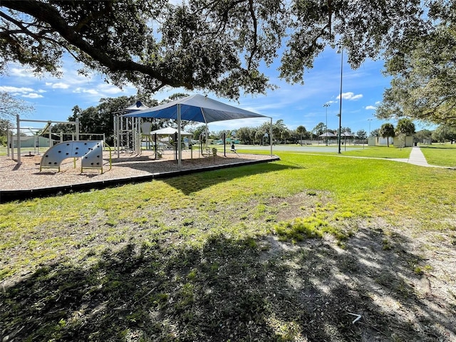 exterior space with a playground and a lawn