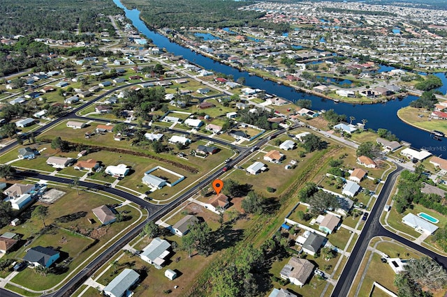 birds eye view of property featuring a residential view and a water view