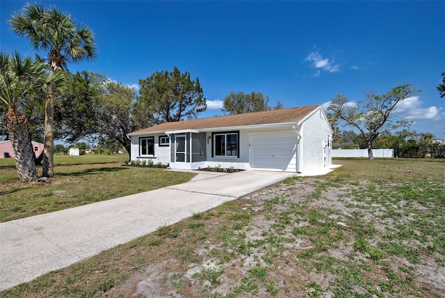 ranch-style home featuring an attached garage, driveway, and a front lawn