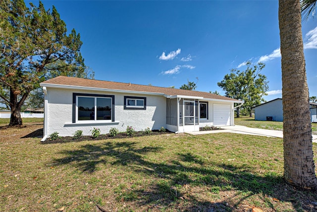 ranch-style house featuring a garage, driveway, a front lawn, and stucco siding