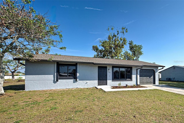 single story home with a garage and a front lawn