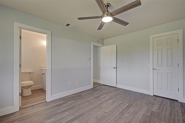 unfurnished bedroom with light hardwood / wood-style floors, ceiling fan, and ensuite bathroom