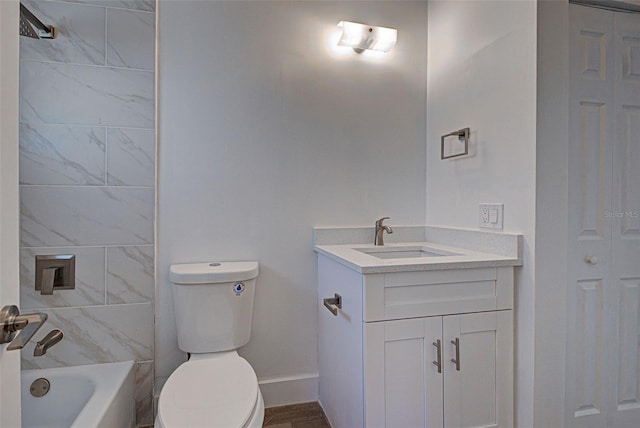 bathroom with washtub / shower combination, a closet, vanity, and toilet