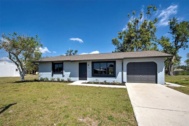 ranch-style house featuring a garage, a front yard, and concrete driveway