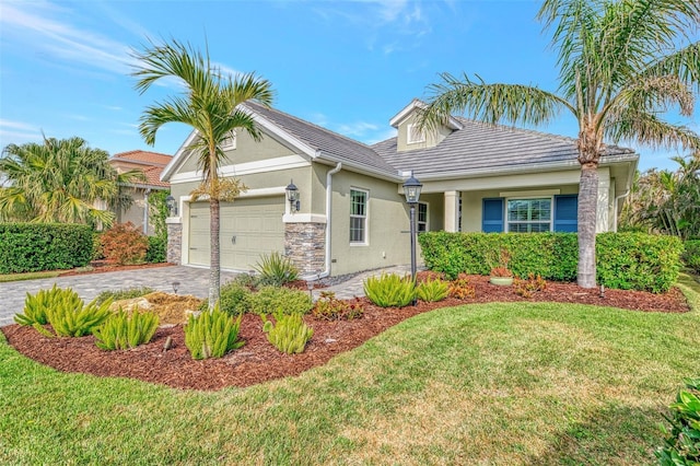 view of front of house with a garage and a front lawn