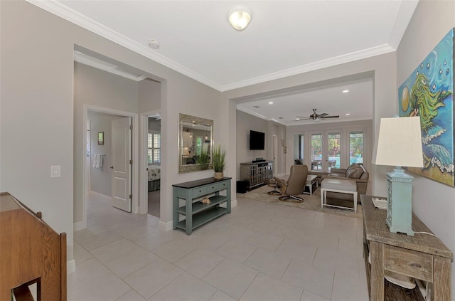 tiled living room featuring ornamental molding, ceiling fan, and french doors