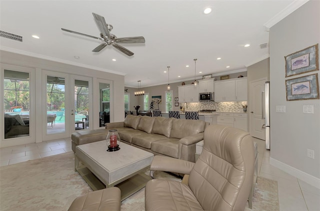 tiled living room with crown molding and ceiling fan