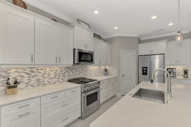 kitchen featuring high end appliances, white cabinetry, pendant lighting, and decorative backsplash