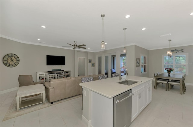 kitchen with sink, hanging light fixtures, stainless steel dishwasher, a kitchen island with sink, and white cabinets