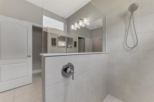 bathroom featuring tiled shower and tile patterned floors