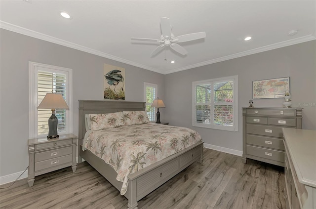 bedroom with crown molding, ceiling fan, multiple windows, and light wood-type flooring