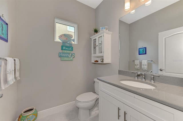 bathroom with tile patterned flooring, vanity, and toilet