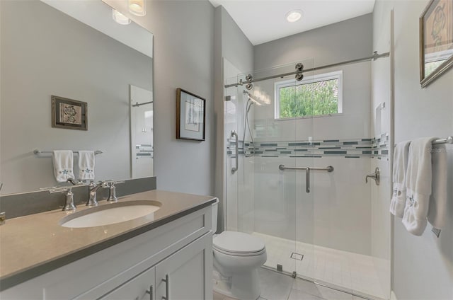 bathroom with an enclosed shower, vanity, tile patterned floors, and toilet