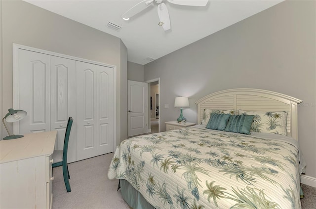 carpeted bedroom with ceiling fan and a closet