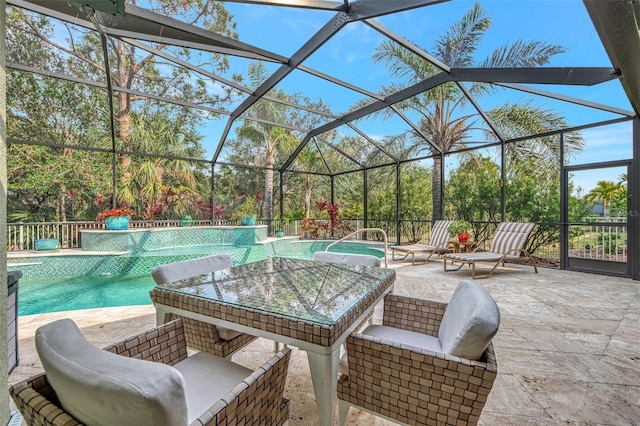 view of pool with a patio area and glass enclosure