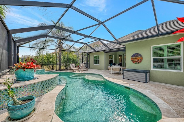 view of swimming pool with a lanai and a patio area