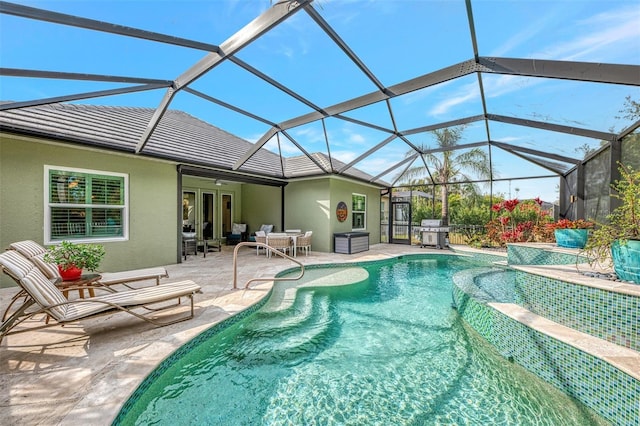 view of pool featuring grilling area, a patio area, and glass enclosure