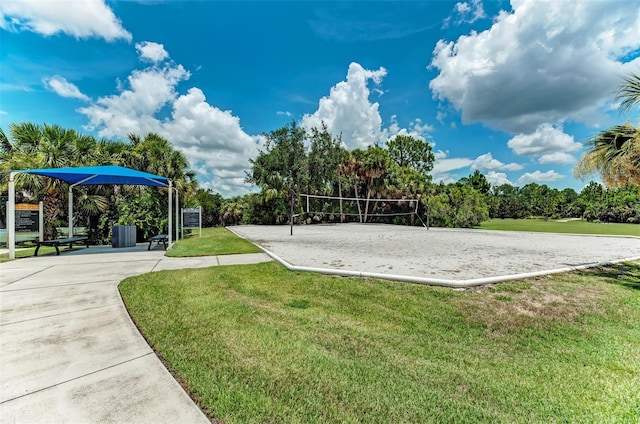 view of property's community with a yard and volleyball court