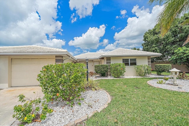 single story home with a garage and a front lawn