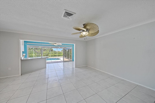 spare room featuring light tile patterned flooring, ceiling fan, and ornamental molding