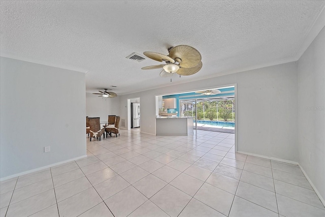 tiled empty room with a textured ceiling and ceiling fan