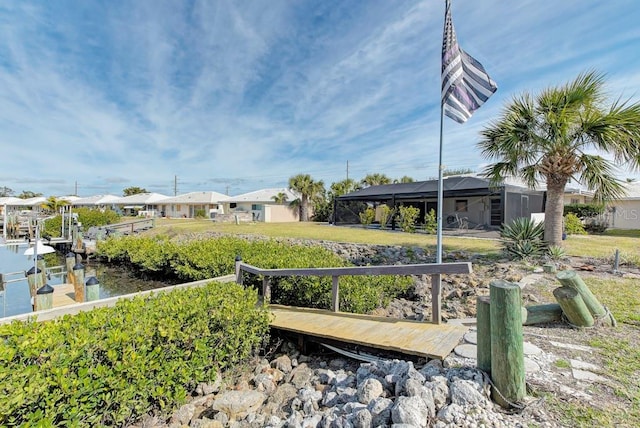 view of yard with a dock and a water view