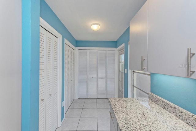 kitchen with light stone counters and light tile patterned flooring