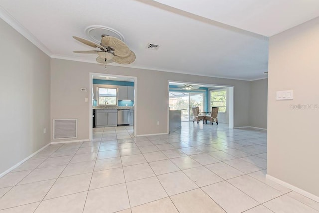 spare room featuring light tile patterned floors, ornamental molding, sink, and ceiling fan