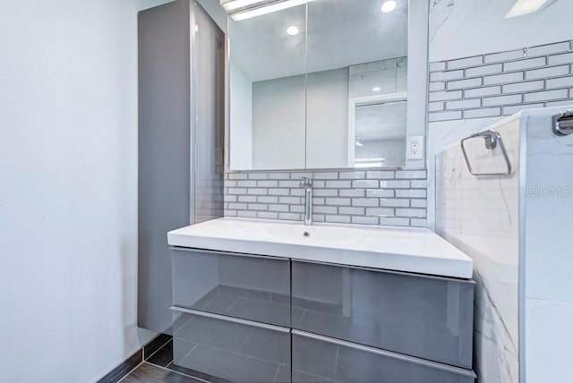 bathroom with tasteful backsplash and vanity