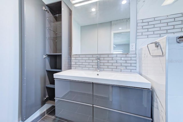 bathroom featuring vanity and backsplash