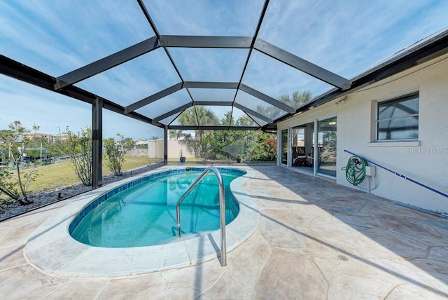 view of swimming pool with a patio and glass enclosure